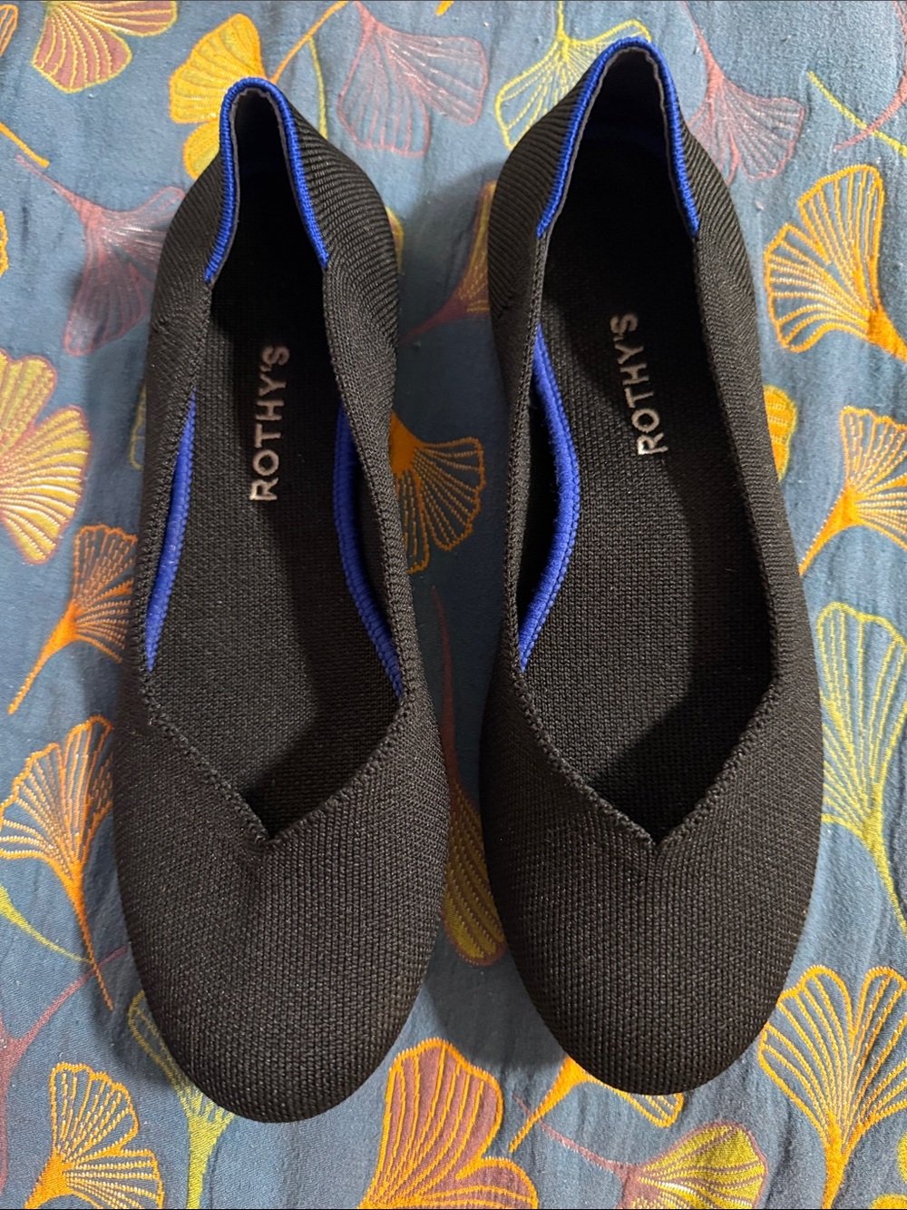 Rothy's Black Slip-On Flats with Blue Trim